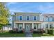 Charming two-story home showcasing inviting front porch with classic architectural details and fresh landscaping at 985 Huntspoint St, Winter Garden, FL 34787
