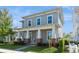 Inviting home featuring a covered porch, a well-maintained lawn, and classic design at 985 Huntspoint St, Winter Garden, FL 34787
