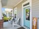 Inviting front porch with blue door and seating area at 985 Huntspoint St, Winter Garden, FL 34787