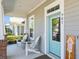 Welcoming front porch with seating, a light blue front door, and crisp white trim at 985 Huntspoint St, Winter Garden, FL 34787