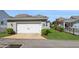 Detached two-car garage with a paved driveway and manicured landscaping at 985 Huntspoint St, Winter Garden, FL 34787