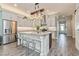 Open concept kitchen with a large island, modern appliances, and light colored cabinets at 985 Huntspoint St, Winter Garden, FL 34787