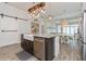 Kitchen island with granite countertop, stainless appliances, and dining area at 985 Huntspoint St, Winter Garden, FL 34787