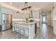Open-concept kitchen featuring stainless appliances, quartz counters and gray cabinets at 985 Huntspoint St, Winter Garden, FL 34787