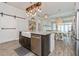 Kitchen island with granite countertops, stainless steel dishwasher, and farm sink at 985 Huntspoint St, Winter Garden, FL 34787