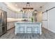 Kitchen island featuring a waterfall countertop and modern appliances at 985 Huntspoint St, Winter Garden, FL 34787