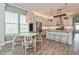 Kitchen and dining area featuring stainless appliances, quartz counters and gray cabinets at 985 Huntspoint St, Winter Garden, FL 34787