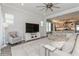 Bright living room featuring a ceiling fan and an open layout flowing into the kitchen at 985 Huntspoint St, Winter Garden, FL 34787
