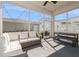 Screened patio with white furniture, an outdoor table, and a view of the backyard and neighboring homes at 985 Huntspoint St, Winter Garden, FL 34787