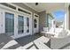 Inviting covered patio with stylish white wicker seating and natural light at 985 Huntspoint St, Winter Garden, FL 34787