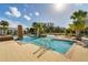Community pool with a shallow entrance, palm trees, and lounge chairs provides a refreshing and relaxing atmosphere at 985 Huntspoint St, Winter Garden, FL 34787
