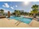 Resort-style community pool with brick accents, sun loungers and palm trees at 985 Huntspoint St, Winter Garden, FL 34787