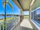 Relaxing porch with scenic waterfront view and stone pillar accents at 9971 Highland Sky Aly, Orlando, FL 32832