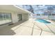 Back patio area with sliding glass doors leading to a private, screened-in pool perfect for relaxation and outdoor enjoyment at 1001 Lester Ridge Ct, Kissimmee, FL 34747