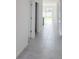 Bright hallway with tiled flooring leading to the backyard and other rooms at 1009 Hendon Loop, Davenport, FL 33837