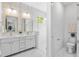 Bright bathroom featuring dual vanities, walk-in glass shower, and stylish decor at 1018 Stetson St, Orlando, FL 32804