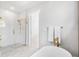 Bright bathroom featuring a soaking tub, separate shower, and gold hardware at 1018 Stetson St, Orlando, FL 32804