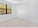 Neutral bedroom featuring a large window and plush carpet at 1018 Stetson St, Orlando, FL 32804