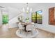 Bright dining room with a round table, modern chandelier, and natural light from a large window at 1018 Stetson St, Orlando, FL 32804