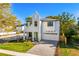 Two-story white home with a brick driveway, well manicured lawn, and green front door at 1018 Stetson St, Orlando, FL 32804