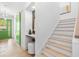 Hallway view featuring a vanity area, staircase, and green door that adds a touch of color at 1018 Stetson St, Orlando, FL 32804