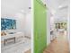 Bright hallway with a green sliding door that opens to an office space at 1018 Stetson St, Orlando, FL 32804