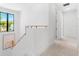 Bright hallway with modern staircase featuring a window, natural light, and neutral tones at 1018 Stetson St, Orlando, FL 32804