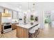 Bright, modern kitchen with an island, white quartz countertops, and stainless steel appliances at 1018 Stetson St, Orlando, FL 32804