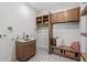 Well-organized laundry room with custom cabinets, sink, countertop, bench, and stylish patterned flooring at 1018 Stetson St, Orlando, FL 32804