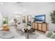 Bright living room featuring stylish furniture, a decorative cabinet, and a view into the dining area at 1018 Stetson St, Orlando, FL 32804