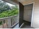 Balcony featuring an open closet/storage space and a white wood railing overlooking lush greenery at 1021 S Hiawassee Rd # 3922, Orlando, FL 32835