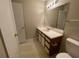 Bright bathroom with a large mirror, vanity with storage, and tiled floors at 1021 S Hiawassee Rd # 3922, Orlando, FL 32835