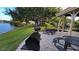 Community outdoor grill and picnic tables overlook green space and lake at 1021 S Hiawassee Rd # 3922, Orlando, FL 32835