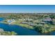 Aerial view of community amenities including tennis courts and a pool by the lake at 1377 Tappie Toorie Cir, Lake Mary, FL 32746