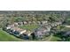 Aerial view of a community surrounded by lush greenery, bodies of water, and a golf course at 1377 Tappie Toorie Cir, Lake Mary, FL 32746