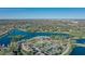 Panoramic aerial view featuring serene lakes, lush greenery, and community amenities like tennis courts and pools at 1377 Tappie Toorie Cir, Lake Mary, FL 32746