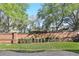 Brick wall bordering green lawn, trees, and lake create privacy for outdoor enjoyment at 1377 Tappie Toorie Cir, Lake Mary, FL 32746