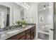 Bathroom featuring double sinks with granite countertops and a view into the bedroom at 1377 Tappie Toorie Cir, Lake Mary, FL 32746