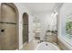 Bright bathroom with dual sink vanity, soaking tub, and tiled shower with glass door at 1377 Tappie Toorie Cir, Lake Mary, FL 32746