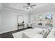 Well-lit bedroom featuring ceiling fan, neutral color palette and tray ceiling at 1377 Tappie Toorie Cir, Lake Mary, FL 32746