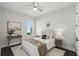 Cozy bedroom with neutral tones, a decorative sunburst mirror and dark wood floors at 1377 Tappie Toorie Cir, Lake Mary, FL 32746