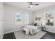 Comfortable bedroom featuring two windows, ceiling fan and ensuite bath at 1377 Tappie Toorie Cir, Lake Mary, FL 32746