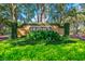 The Heathrow community entrance with a brick sign, manicured hedges, and vibrant greenery welcomes visitors with a sense of exclusivity at 1377 Tappie Toorie Cir, Lake Mary, FL 32746