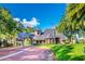 Grand stone gated entrance to a residential community, featuring manicured lawns, trees, and an American flag at 1377 Tappie Toorie Cir, Lake Mary, FL 32746