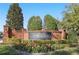 Beautifully landscaped entrance to Turnberry featuring a brick sign and colorful flowerbeds at 1377 Tappie Toorie Cir, Lake Mary, FL 32746