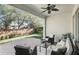 Relaxing covered patio featuring comfortable seating, stylish decor, and a ceiling fan at 1377 Tappie Toorie Cir, Lake Mary, FL 32746