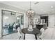 Dining room with backyard views, modern chandelier, and open to the kitchen and living area at 1377 Tappie Toorie Cir, Lake Mary, FL 32746