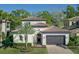 Charming two-story home with a tile roof, manicured landscaping, and a two-car garage, showcasing its desirable curb appeal at 1377 Tappie Toorie Cir, Lake Mary, FL 32746