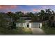 Twilight shot of single Gathering home, manicured lawn, neutral paint and gray garage door at 1377 Tappie Toorie Cir, Lake Mary, FL 32746