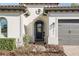 Close-up of front door, tiled roofline and an attached two-car garage at 1377 Tappie Toorie Cir, Lake Mary, FL 32746